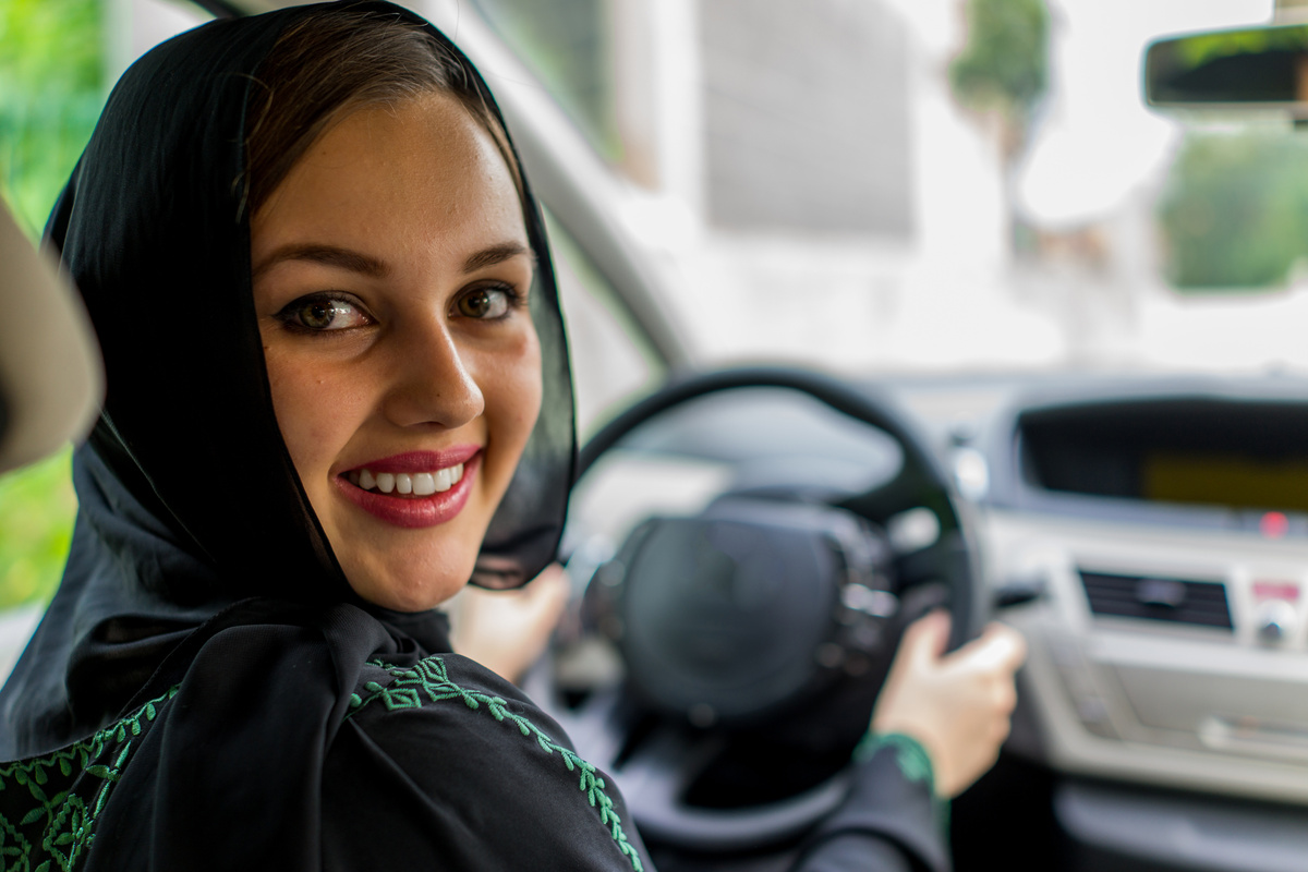Happy Muslim Woman Driving Car